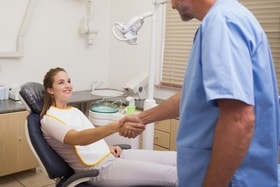 dentist shaking hands with patient